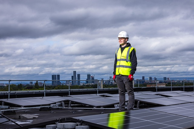 Person standing on solar panel rooftop.